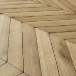 Angle view of textured chevron wood floor.