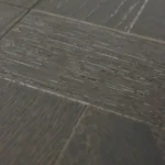 Detail of textured grey wood grain on tile.