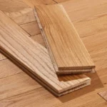 Two oak tongue-and-groove wood floor planks