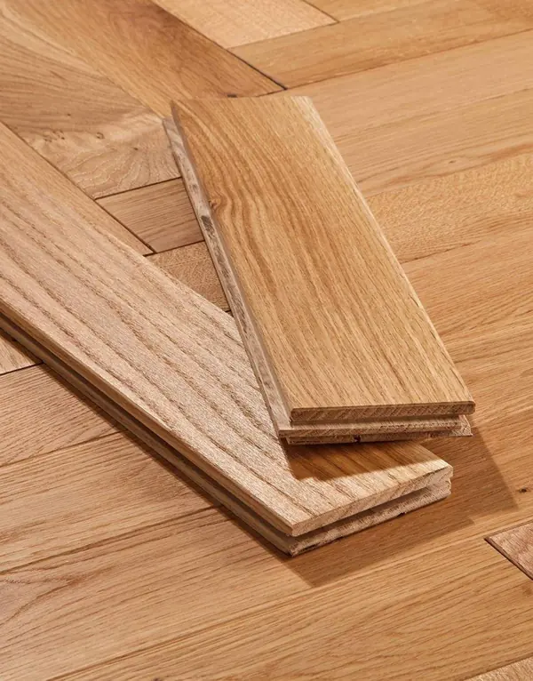 Two oak tongue-and-groove wood floor planks