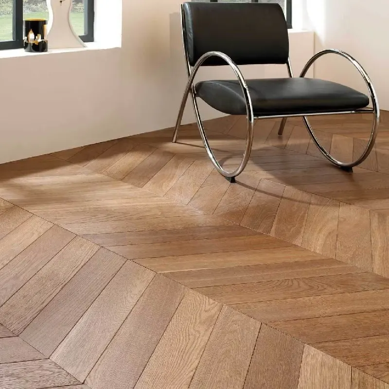 close-up of light-toned wooden chevron-patterned flooring