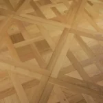 grain texture and precise joinery of light-colored natural oak parquet flooring.