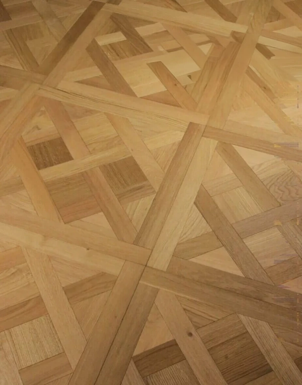 grain texture and precise joinery of light-colored natural oak parquet flooring.