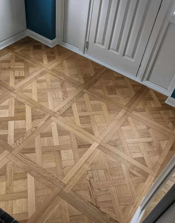 high-angle shot of a room with a classic Versailles parquet floor pattern in natural oak.