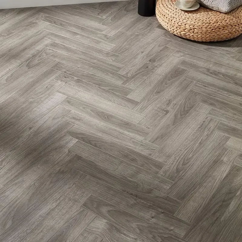 Grey wood effect herringbone flooring.