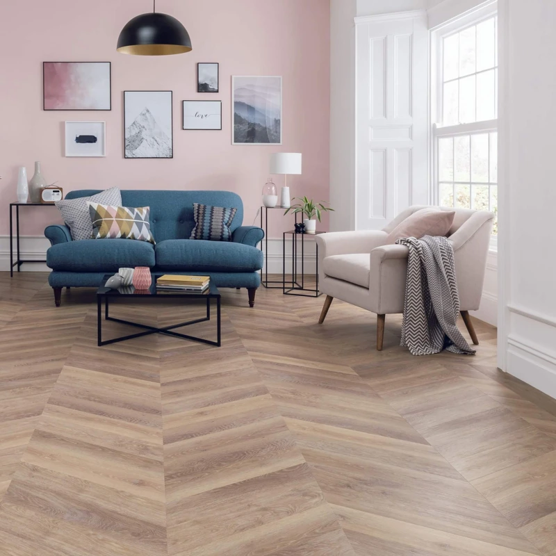 Light brown chevron flooring in a living room.