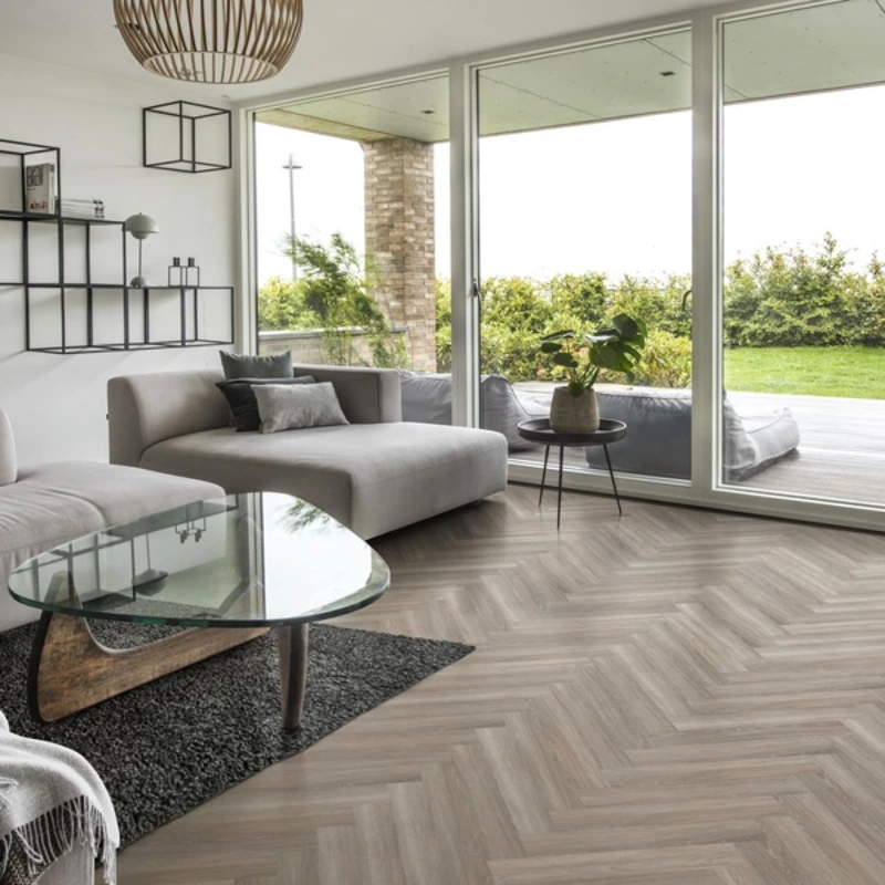 Light grey herringbone flooring in a modern living room.