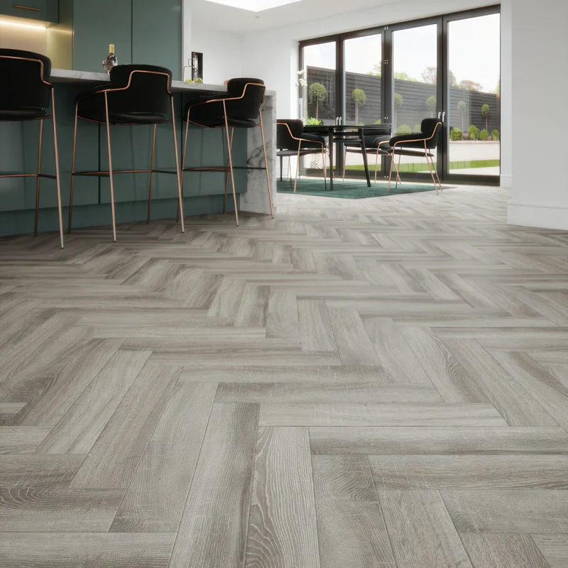 Light grey wood effect herringbone flooring in a modern kitchen.