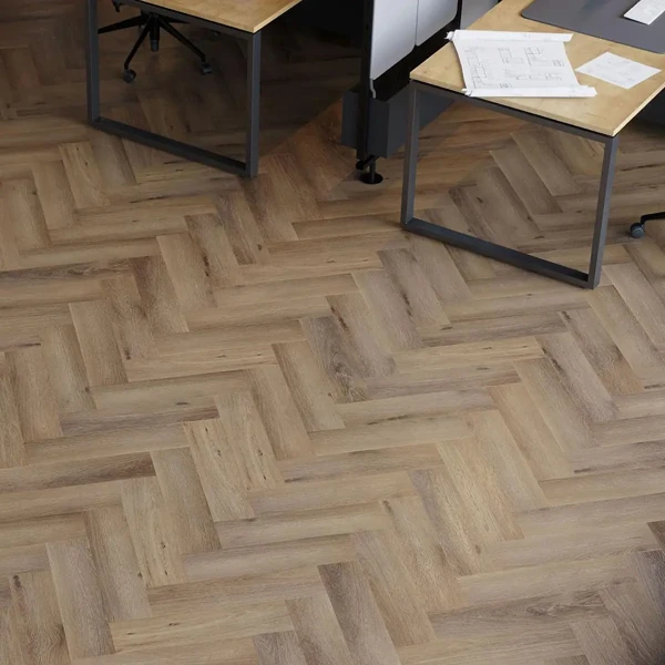 Office interior with herringbone LVT flooring and modern desks.