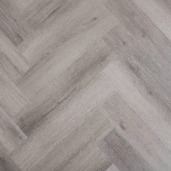 SPC flooring in a cool light gray wood grain herringbone design