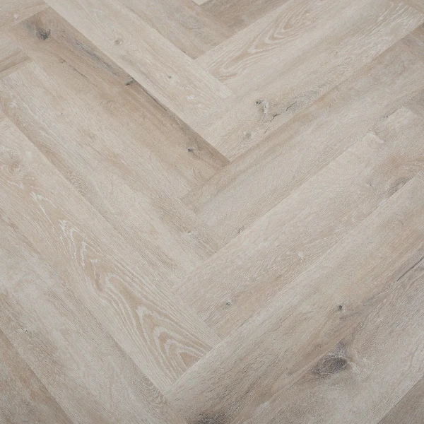 SPC flooring in an extra light, whitewashed wood grain pattern herringbone design