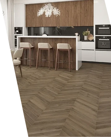 Brown wood chevron parquet flooring in a modern kitchen