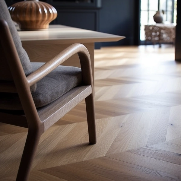 Chevron-pattern light oak parquet flooring in a modern living room