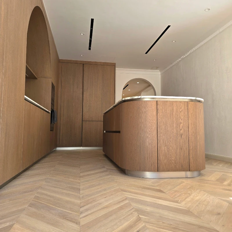 Large-scale Chevron oak parquet flooring in a kitchen