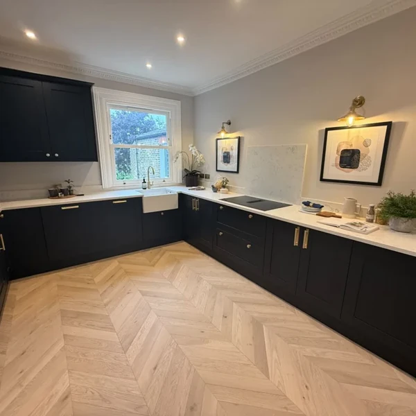 Light oak chevron parquet flooring in a modern kitchen