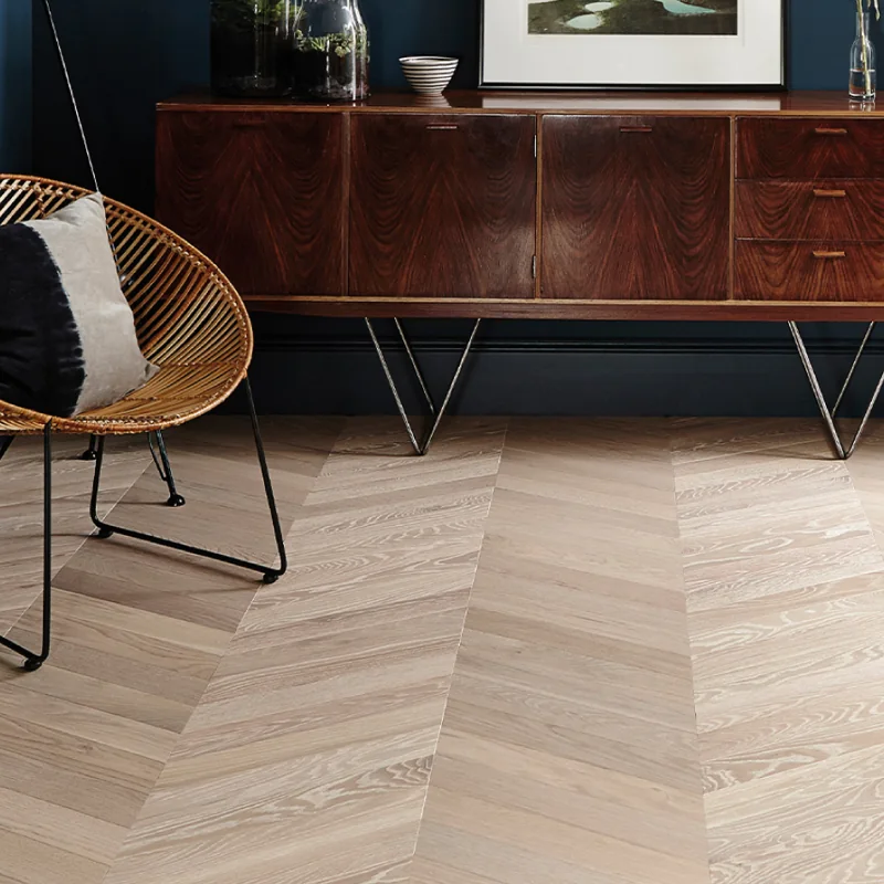Light oak chevron parquet flooring in a stylish room