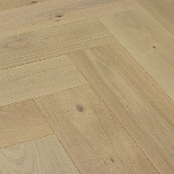 Light oak herringbone wood flooring with natural grain and knots