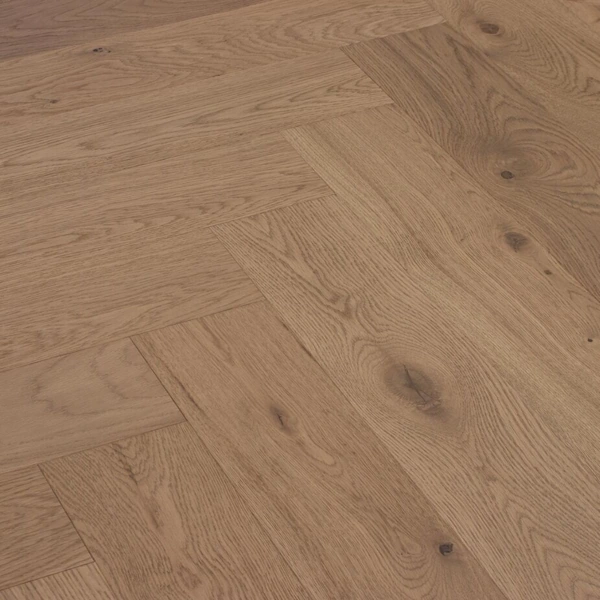 Light oak herringbone wood flooring with visible knots and grain