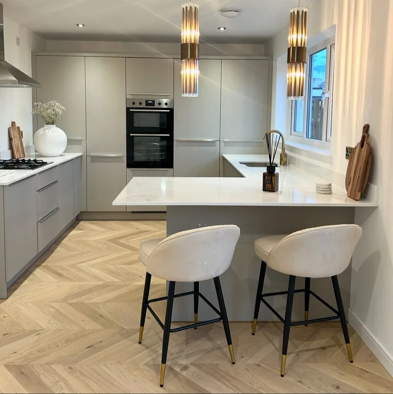 Light wood chevron parquet flooring in a modern kitchen