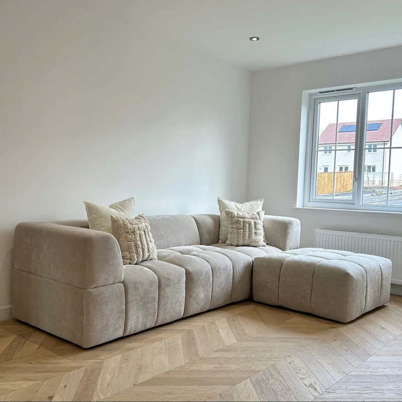 Light wood chevron parquet flooring in a modern living room