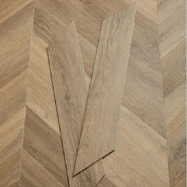 Medium-brown, textured wood-look flooring planks in a chevron pattern