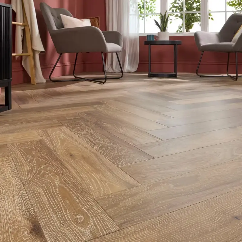 Warm wood engineered parquet flooring laid in a herringbone pattern