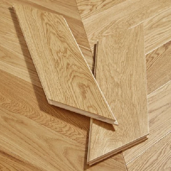 golden-toned natural oak flooring planks with a clear grain, in a chevron pattern