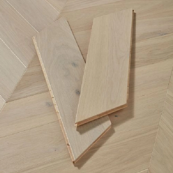 grey-washed wood flooring planks in a chevron pattern