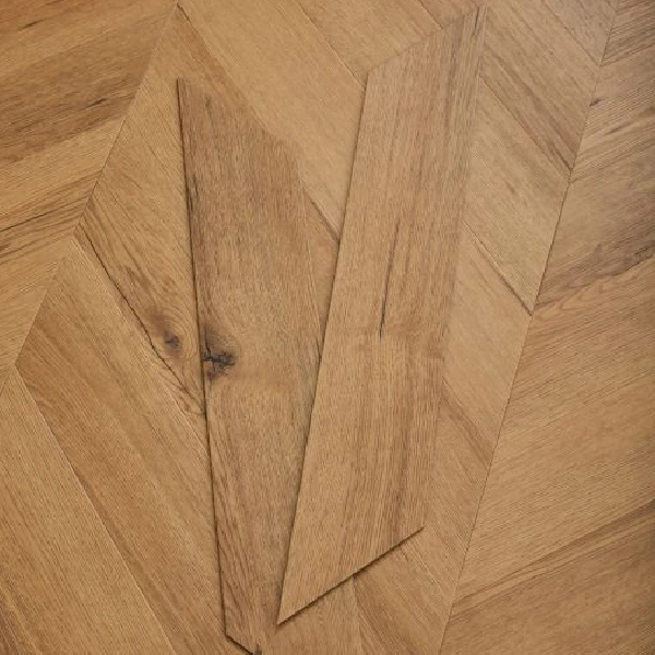 honey-toned wood-look flooring planks with knots, arranged in a chevron pattern